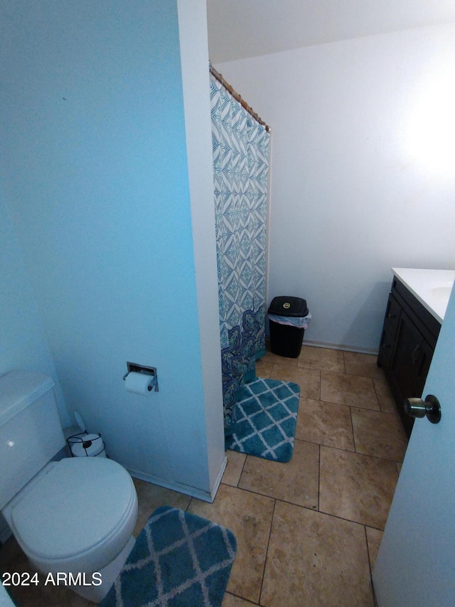 bathroom featuring tile patterned flooring, vanity, and toilet