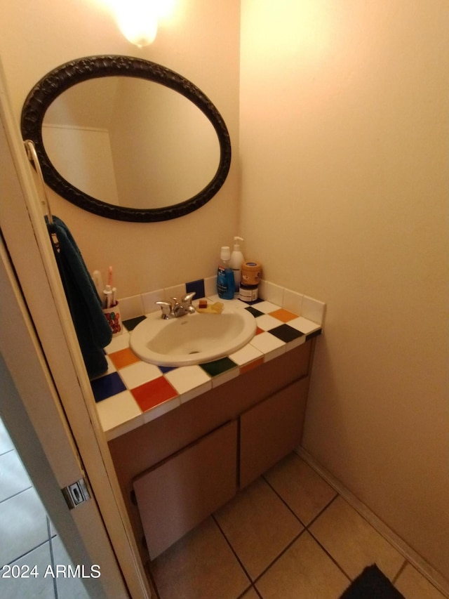 bathroom featuring tile patterned flooring and vanity