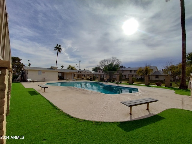 view of pool with a yard and a patio area