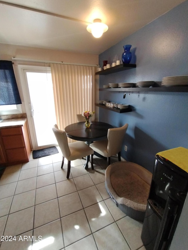 dining area with light tile patterned floors and washer / dryer