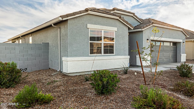 view of side of property with a garage