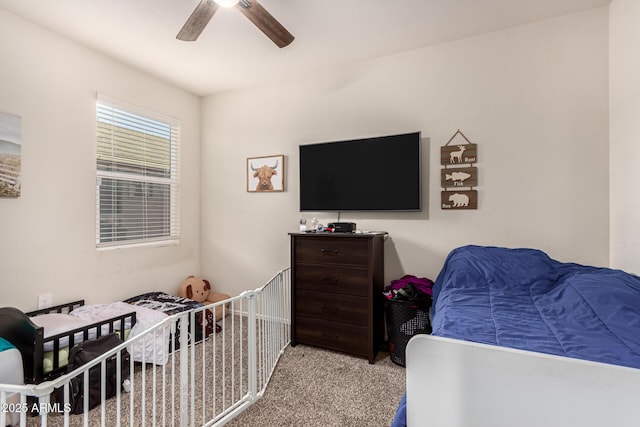 bedroom featuring light colored carpet and ceiling fan