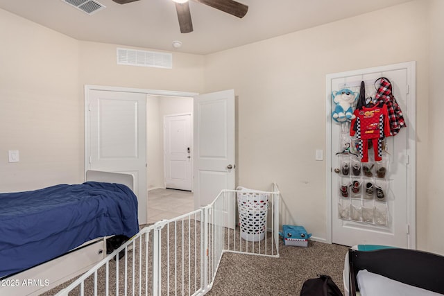 bedroom with ceiling fan and light carpet