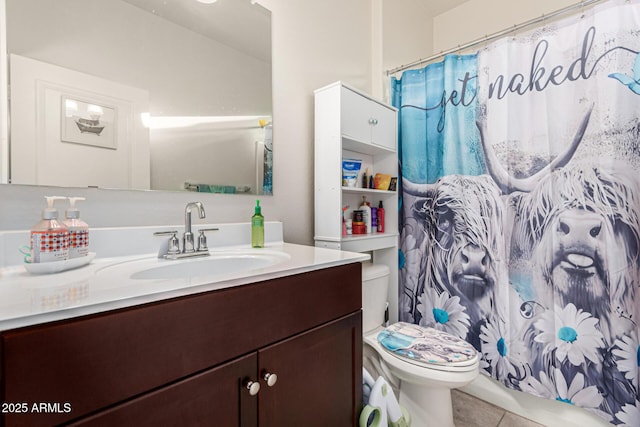 bathroom with vanity, toilet, curtained shower, and tile patterned flooring