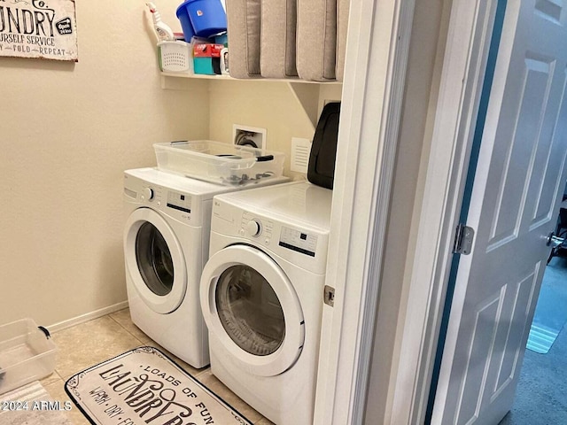 laundry area featuring independent washer and dryer and light tile patterned floors