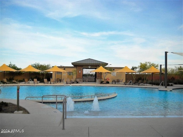 view of swimming pool featuring a patio and pool water feature