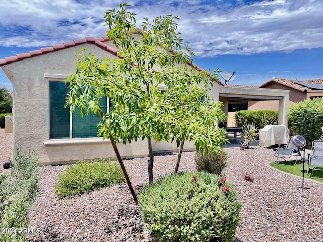 view of side of property with a patio area