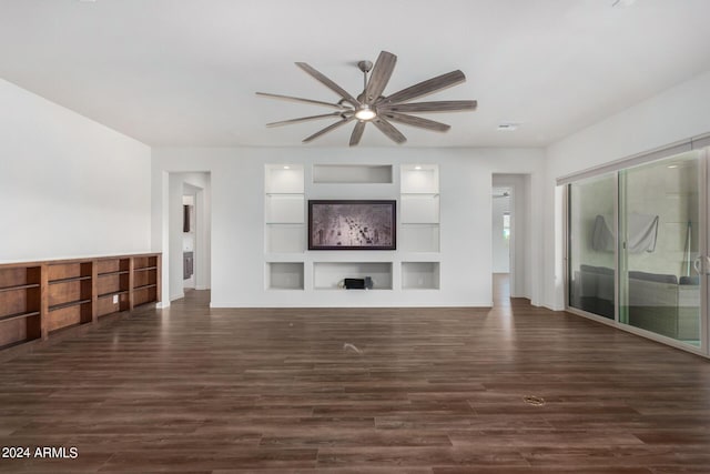 unfurnished living room featuring ceiling fan, dark hardwood / wood-style flooring, and built in shelves