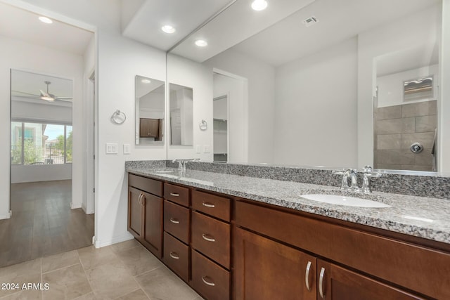 bathroom featuring walk in shower, vanity, tile patterned floors, and ceiling fan