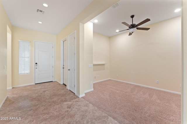 entryway with light colored carpet and ceiling fan