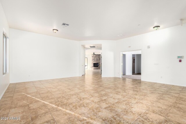 unfurnished room featuring a fireplace