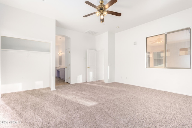 carpeted spare room with ceiling fan