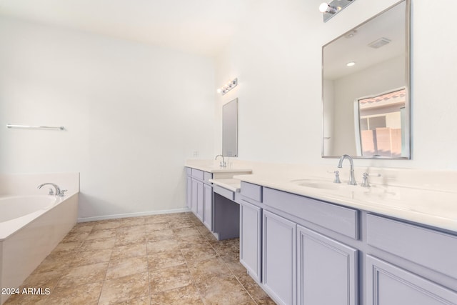 bathroom featuring vanity and a tub