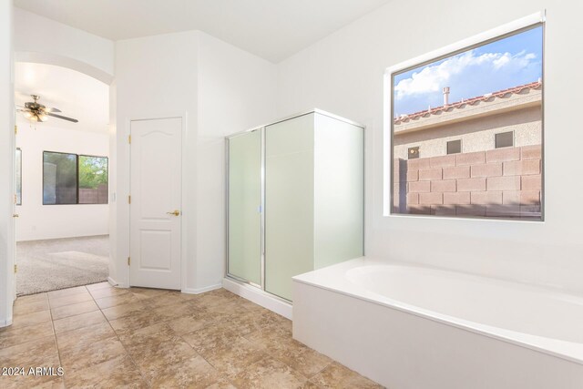 bathroom with independent shower and bath and ceiling fan