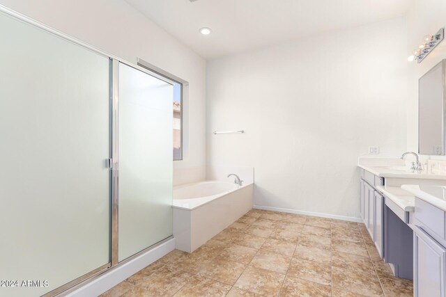 bathroom with vanity and separate shower and tub