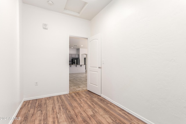 unfurnished room with wood-type flooring