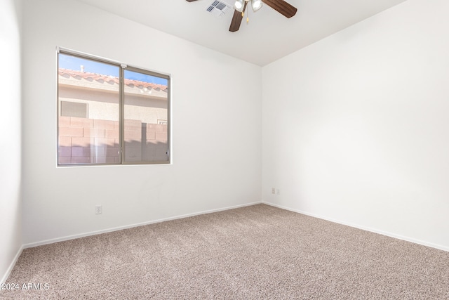 empty room with ceiling fan and carpet flooring