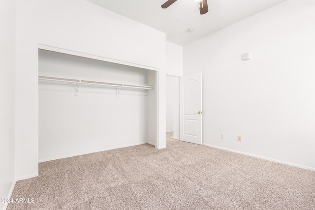 unfurnished bedroom with carpet, ceiling fan, and a closet