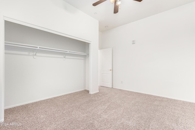 unfurnished bedroom featuring ceiling fan, a closet, and carpet flooring