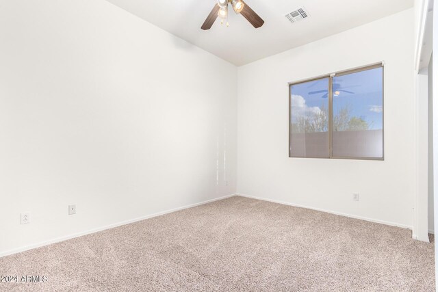 empty room featuring ceiling fan and carpet floors