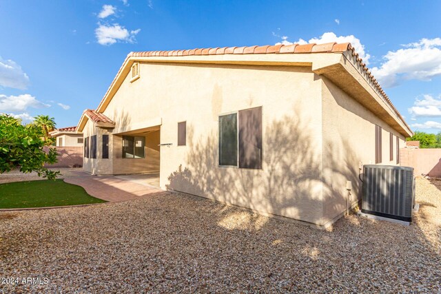 back of house with a patio and central AC unit