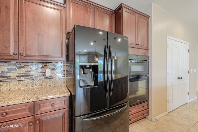 kitchen with light tile patterned flooring, light stone counters, tasteful backsplash, baseboards, and black appliances