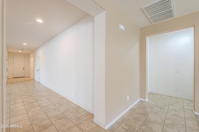 corridor featuring baseboards, visible vents, recessed lighting, and light tile patterned floors