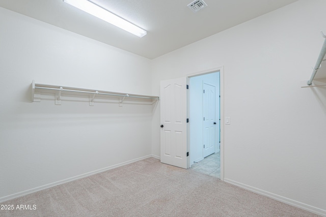 walk in closet featuring carpet and visible vents