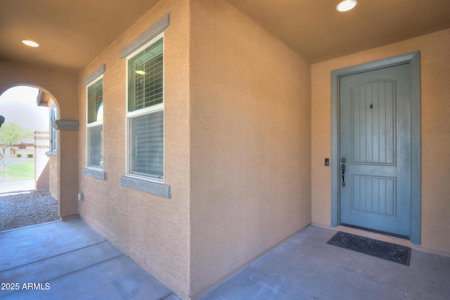 property entrance featuring stucco siding
