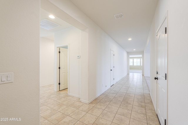 hallway featuring light tile patterned floors, recessed lighting, baseboards, and visible vents