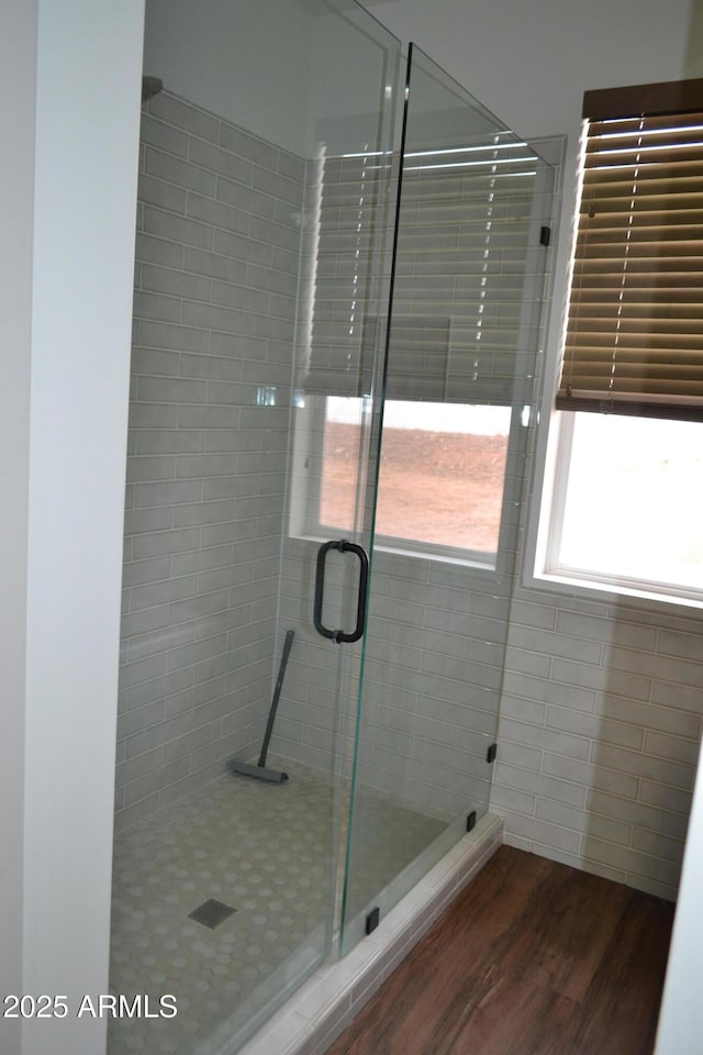 bathroom featuring a stall shower and wood finished floors