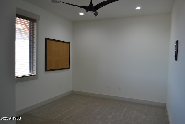 empty room with ceiling fan, dark colored carpet, recessed lighting, and baseboards