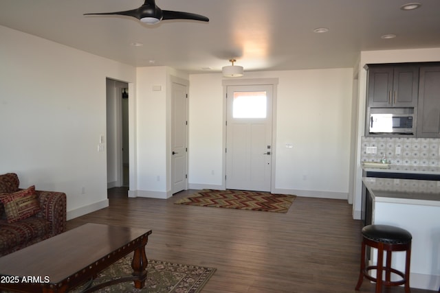 entrance foyer with ceiling fan, dark wood-type flooring, recessed lighting, and baseboards