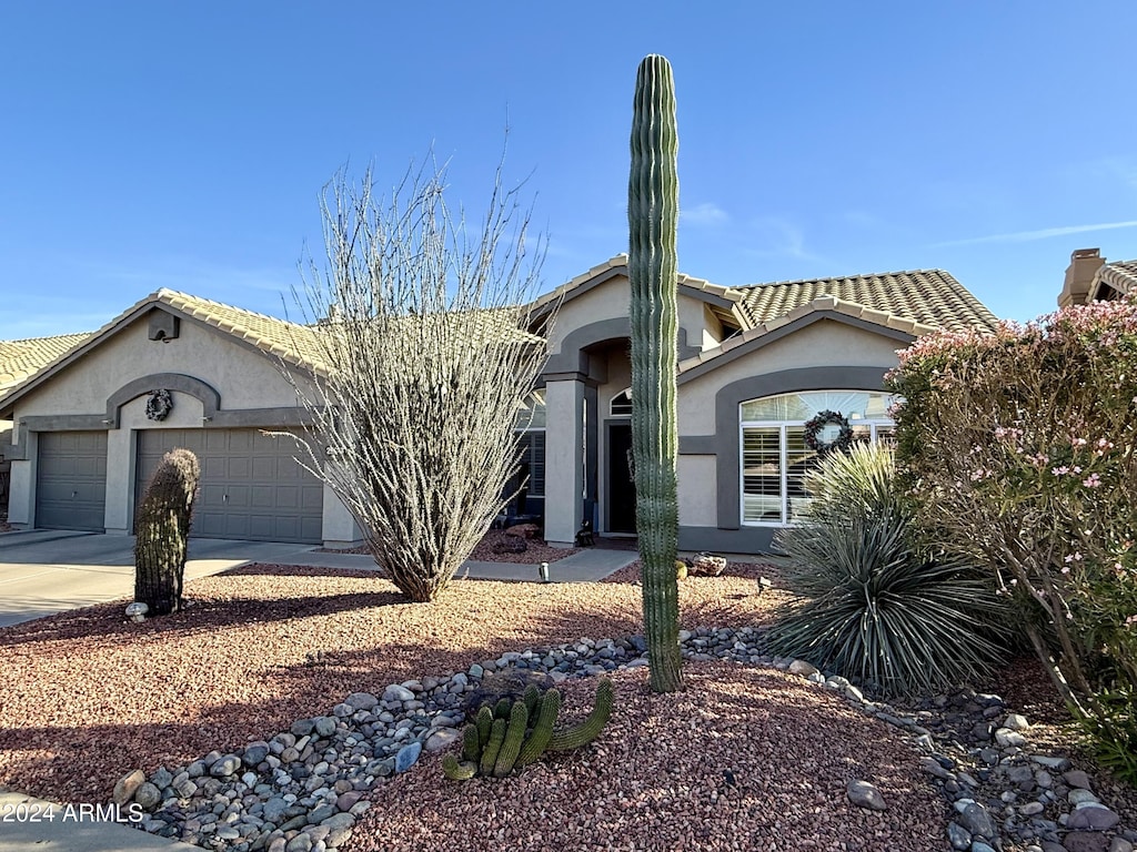 ranch-style house featuring a garage