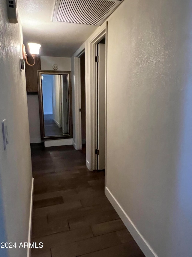 hallway featuring dark wood-type flooring