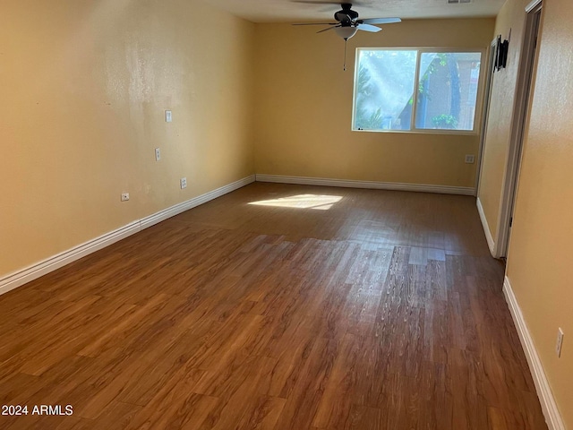 spare room with hardwood / wood-style flooring and ceiling fan