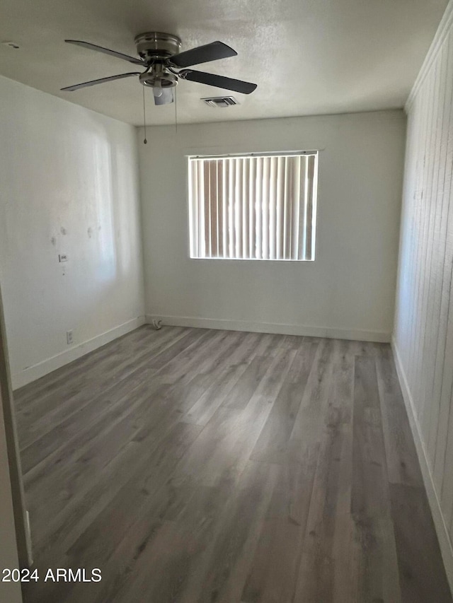 spare room with hardwood / wood-style flooring and ceiling fan