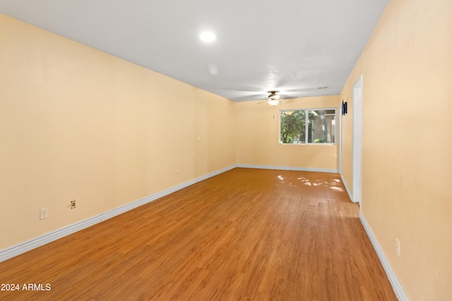 unfurnished room with light wood-type flooring and ceiling fan