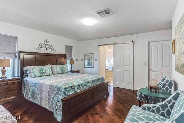 15009 E Palomino Blvd, Fountain Hills, AZ 85268 - bedroom featuring a barn door, dark wood finished floors, multiple windows, and ensuite bath