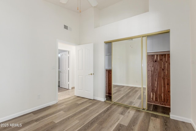 15009 E Palomino Blvd, Fountain Hills, AZ 85268 - unfurnished bedroom with wood finished floors, a closet, and a towering ceiling