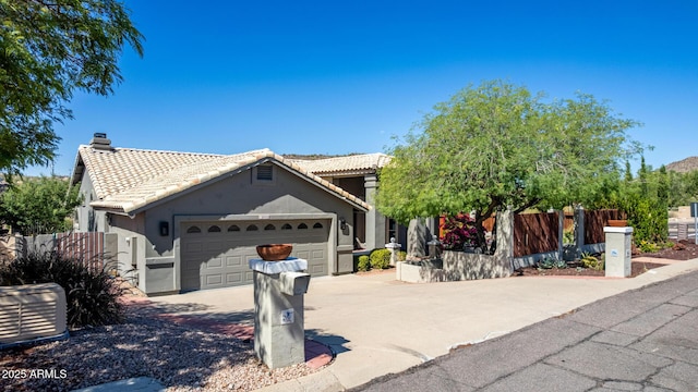 15009 E Palomino Blvd, Fountain Hills, AZ 85268 - view of front of home featuring a tiled roof, an attached garage, concrete driveway, and stucco siding