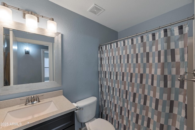 bathroom featuring a textured wall, vanity, toilet, a shower with shower curtain, and visible vents