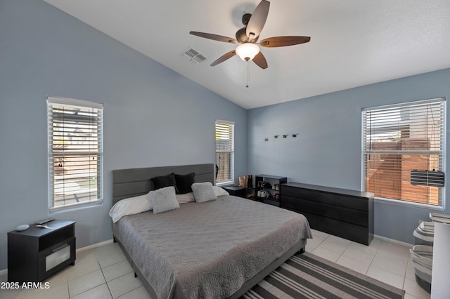 bedroom with baseboards, vaulted ceiling, light tile patterned flooring, and visible vents