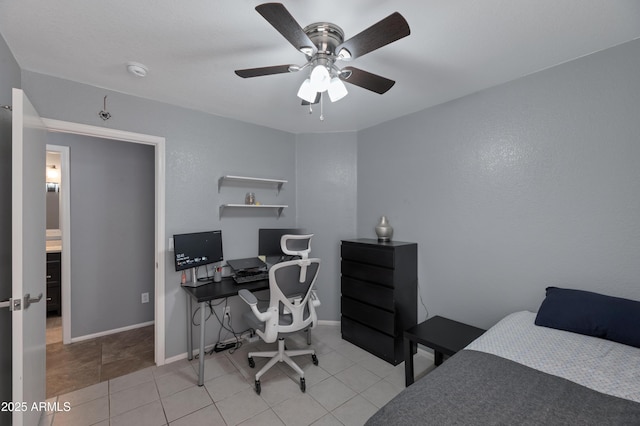 tiled bedroom featuring baseboards and a ceiling fan