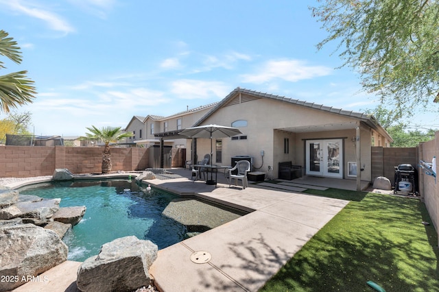 view of pool featuring a patio, a fenced in pool, french doors, and a fenced backyard