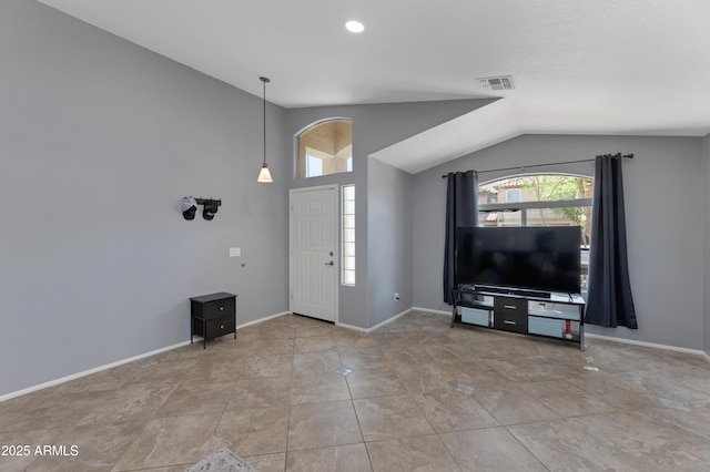 entryway with visible vents, baseboards, tile patterned floors, and vaulted ceiling