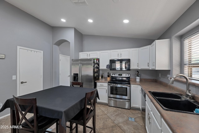 kitchen with visible vents, a sink, appliances with stainless steel finishes, and white cabinets