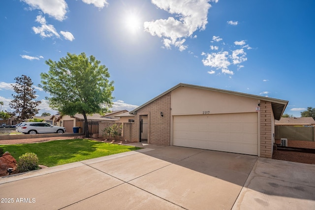 view of front of home with brick siding, stucco siding, concrete driveway, a front yard, and fence