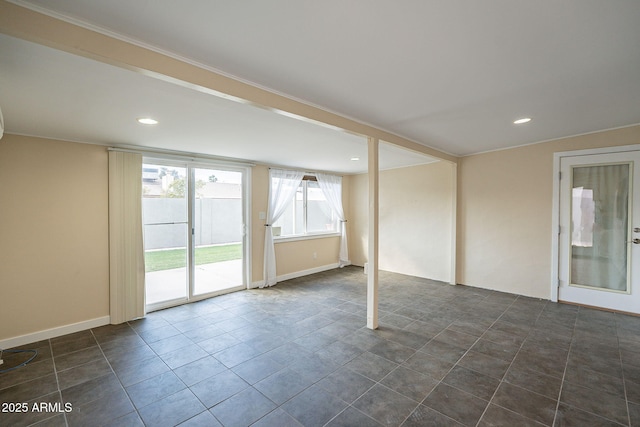 unfurnished room with baseboards, dark tile patterned flooring, and recessed lighting