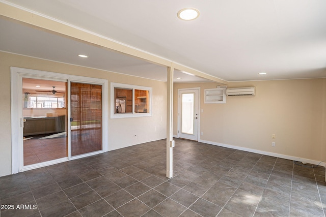 empty room with recessed lighting, a wall mounted air conditioner, and baseboards